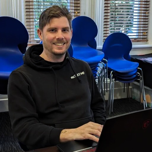 Image of Shawn sitting at a desk